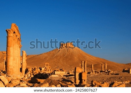 The Bel Temple in Palmyra, Syria, is an ancient architectural marvel. Majestic columns and intricate carvings adorn its facade, reflecting a blend of Roman and Semitic influences. The temple, dedicate Royalty-Free Stock Photo #2425807627