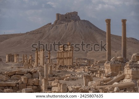 The Bel Temple in Palmyra, Syria, is an ancient architectural marvel. Majestic columns and intricate carvings adorn its facade, reflecting a blend of Roman and Semitic influences. The temple, dedicate Royalty-Free Stock Photo #2425807635