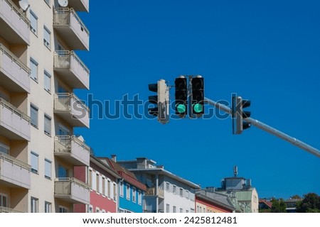 green traffic light in city landscape