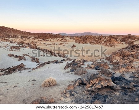 Scenery in El Teide crater on Tenerife. Dry volcanic orange and red landscape during sunset
