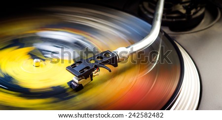 Tonearm on a spinning color picture vinyl.