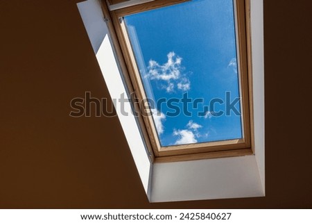 Interior shot of a roof window. Dormer window. Roof window, Skylight Royalty-Free Stock Photo #2425840627
