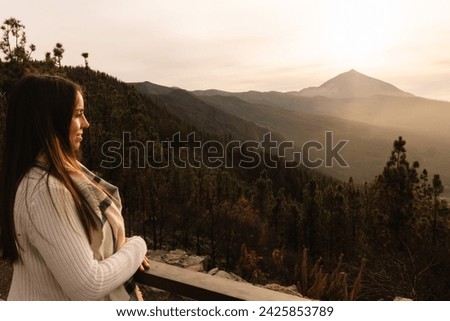 Woman at the lookout point observing the Teide in the background