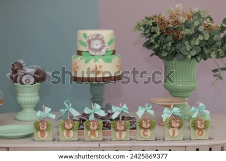 cake decorated for baby boy's 1st birthday party lion theme pastel colors green