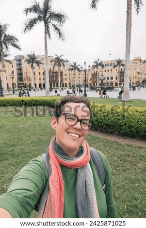 Woman with glasses taking a selfie in the streets of Lima Peru