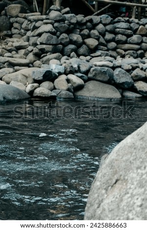 River stones, usually the children who live around the river have fun arranging pebbles from the largest to the smallest. Whoever is the tallest in setting it up is the great one. Royalty-Free Stock Photo #2425886663