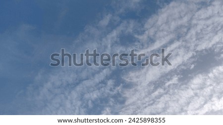 Blue skies full of fluffy white clouds Royalty-Free Stock Photo #2425898355