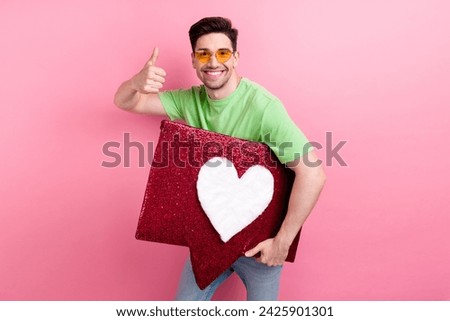 Photo of young youtube production manager thumb up hold collage red heart notification reaction for video isolated on pink color background