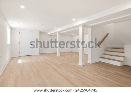 Minimalist Empty Room with Blond Hardwood Floors for Design and Layout Inspiration. Family Room, Den, Finished Basement, Living Room, Garden Apartment. Empty for Virtual Staging. Royalty-Free Stock Photo #2425904745