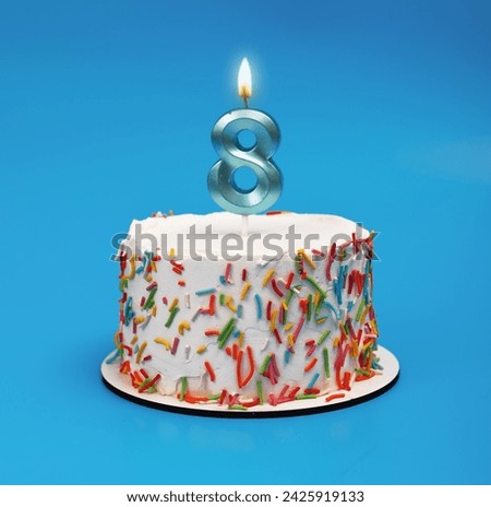 8 shaped candle light on happy birthday cake on blue