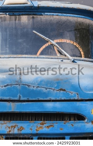 It is close up view of broken pickup. This is photo of rusty blue cabin of old truck. It's view of retro lorry in a sunny day