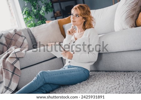 Profile photo of lovely creative minded person sit carpet floor hold notepad pen contemplate brainstorm pastime flat inside
