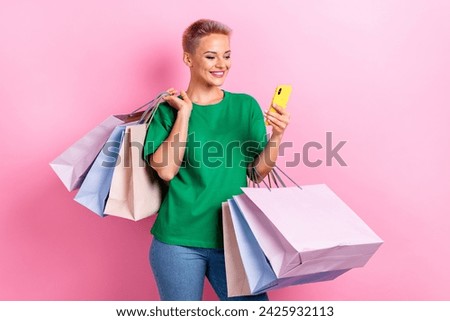 Photo of lovely cheerful woman wear trendy green clothes hold phone read special news total sale isolated on pink color background