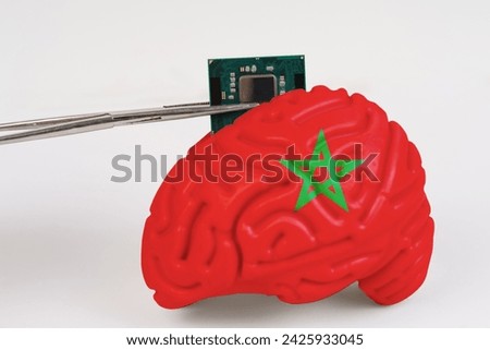 On a white background, a model of the brain with a picture of a flag - Morocco, a microcircuit, a processor, is implanted into it. Close-up