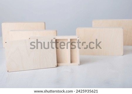 Wooden photo boxes with emply cover, for photo storage on wooden white background. Open box. set for the photographer, presentable set of photos, luxury feedback to client. Royalty-Free Stock Photo #2425935621