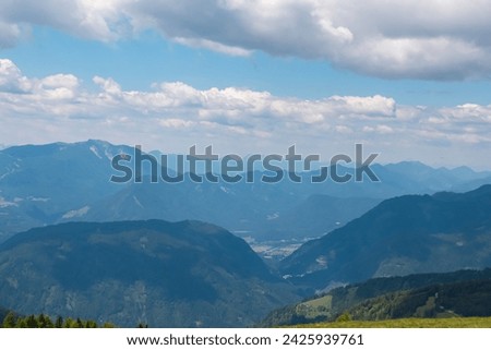 Panoramic view of Dobratsch and Villach surrounded by mountain peaks of Karawanks and Julian Alps. Wanderlust on Gerlitzen Alpe, Carinthia, Austria. Idyllic hiking trail in Austrian Alps in summer Royalty-Free Stock Photo #2425939761