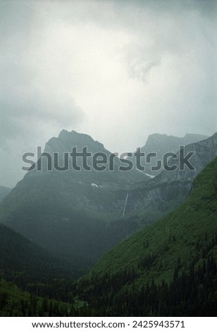Vertical film photo of mountains in rain