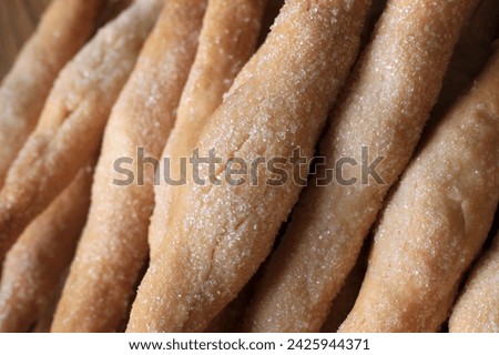 A batch of freshly baked zezette fingers. Royalty-Free Stock Photo #2425944371