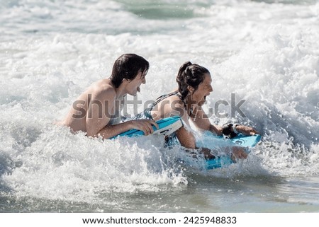 boogie boarding surfing on the waves of hawaii  Royalty-Free Stock Photo #2425948833