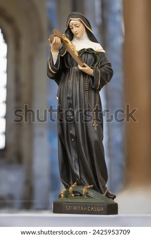 Statue of Santa Rita de  Cassia in blurred religious church background