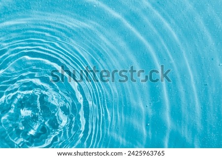 drops on water with circles on a blue background close up