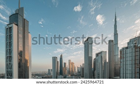 Aerial sunrise view of Dubai Downtown skyline with many towers night to day transition timelapse. Business area in smart urban city. Skyscrapers and high-rise buildings from above early morning, UAE. Royalty-Free Stock Photo #2425964721