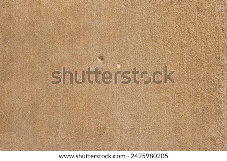 Beige-brown House Wall with Dents: Fascinating Concrete Texture Up Close