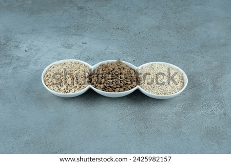 Sunflower and pumpkin seeds with rice grains in white cups. High quality photo