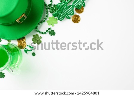St. Patrick's Day celebration: emerald elegance. Top view of traditional green leprechaun hat, green shamrock confetti, gold coins, mug of green beer on white background with space for festive text