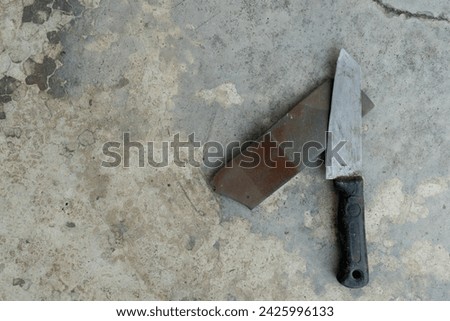 Knife place on knife sharpening stone. Background of cement floor. Royalty-Free Stock Photo #2425996133