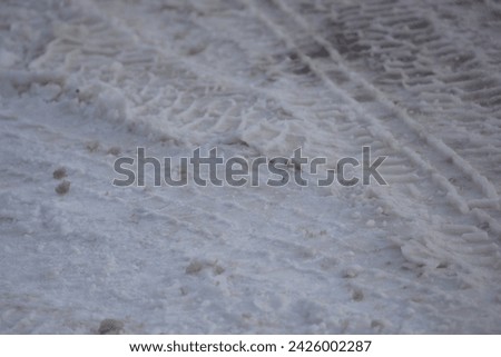 Tire tracks imprinted in snow Royalty-Free Stock Photo #2426002287