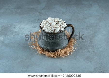 White beans in an ethnic metallic pot. High quality photo