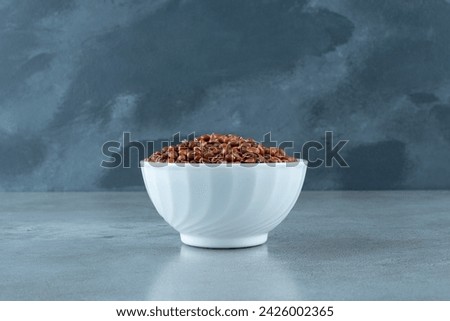 Brown beans in a white ceramic cup. High quality photo