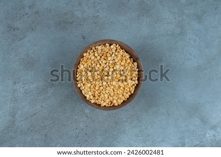 Raw pea beans in a cup on blue background. High quality photo