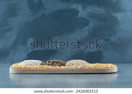 Rice, pumpkin and sunflower seeds on a white platter. High quality photo