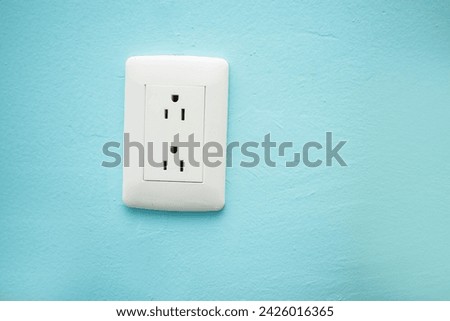 Image of a house electricity outlet on a blue wall