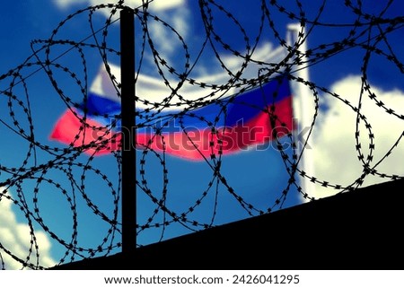 Flag of Russia behind the barbed wire Royalty-Free Stock Photo #2426041295