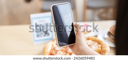 Woman use smartphone to scan QR code to pay in cafe restaurant with a digital payment without cash. Choose menu and order accumulate discount. E wallet, technology, pay online, credit card, bank app