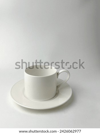 Plain white tea or coffee cup. Empty and clean drink ware object photography isolated on vertical ratio white studio background.