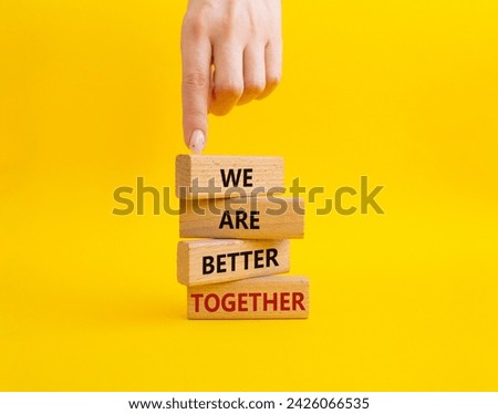 We are better together symbol. Wooden blocks with words We are better together. Beautiful yellow background. Businessman hand. We are better together concept. Copy space. Royalty-Free Stock Photo #2426066535