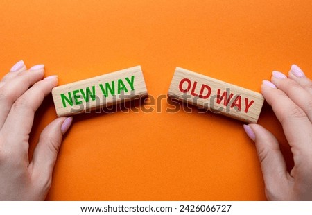 New Way or Old Way symbol. Concept word New Way or Old Way on wooden blocks. Businessman hand. Beautiful orange background. Business  concept. Copy space