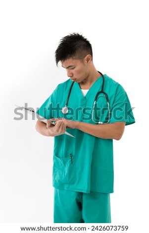 Chinese doctor wearing a green scrubs. Isolated on white.