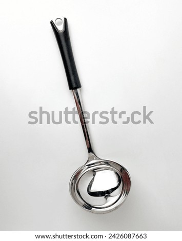 Soup ladle stainless steel spoon. Cooking kitchen utensil tools isolated object photography on white studio background.