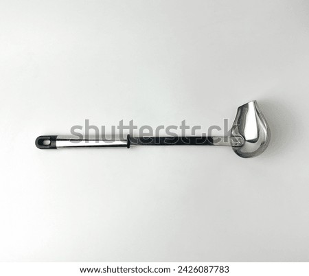 Small stainless steel soup ladle spoon. Cooking kitchen utensil tools isolated object photography on white studio background.