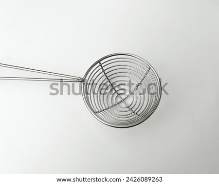 Close up small round spiral strainer. Cooking kitchen utensil tools isolated object photography on white studio background.