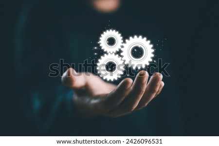 RPA, Business robotic process automation concept. Businessman hold virtual gear icon for improve productivity and management efficiency. Royalty-Free Stock Photo #2426096531