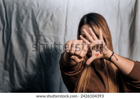 Women in fear of violence. Enough! 8th March, International Women Day. Vulnerable women yearning for freedom without abuse. Not one woman less, women demanding equality. Royalty-Free Stock Photo #2426104393