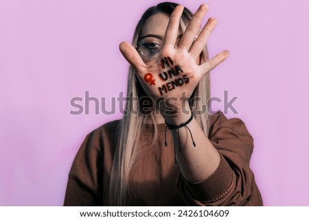 Women in fear of violence. Enough. 8th March, International Women Day. Vulnerable women yearning for freedom without abuse. Not one woman less, women demanding equality. Purple background. Woman cryin Royalty-Free Stock Photo #2426104609