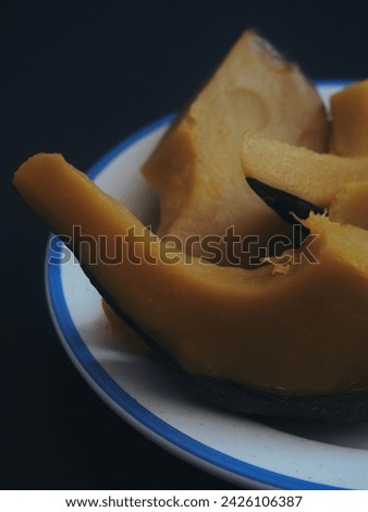 steamed pumpkin in a plate on a black background