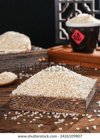 Close-up shot of germ rice in container indoors, Chinese pearl rice, grain (the word "fu" means good luck and blessing in Asian countries)